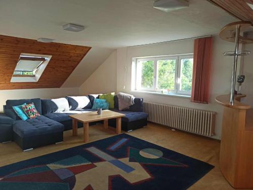 a living room with a blue couch and a table at 3 patro v RD VRATIMOV in Vratimov