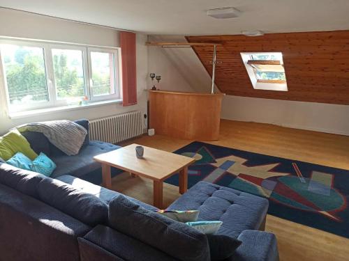 a living room with a blue couch and a table at 3 patro v RD VRATIMOV in Vratimov