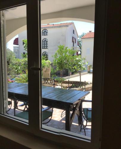 a view of a table from a window at Private Patio Przno Steps to Beach 2 Bedroom 2 Parkings BBQ Villa Olive in Sveti Stefan