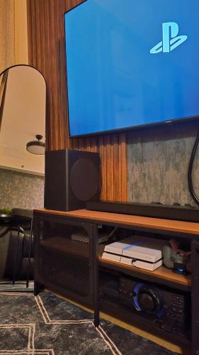 a flat screen tv sitting on top of a entertainment center at SW Staycation Sam Suite SMDC Hope Residences Beside SM City in Trece Martires