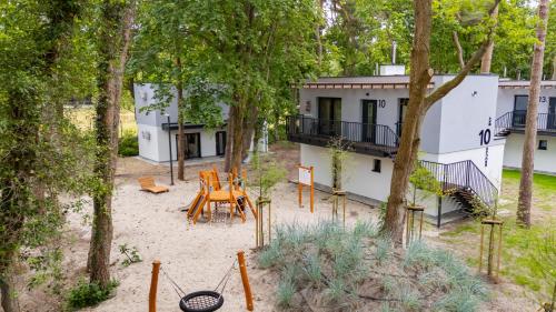 an aerial view of a house with a patio and trees at Baltic Forest in Kołobrzeg