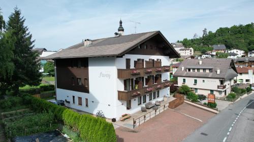 a large white building with a black roof at Hotel Garni Savoy - new opening in Castelrotto