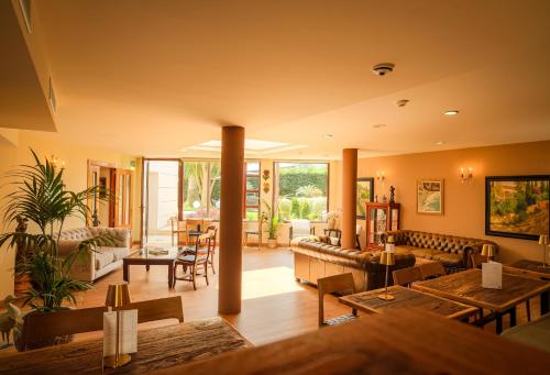 a living room with couches and tables at Indiana Boutique Hotel in Llanes