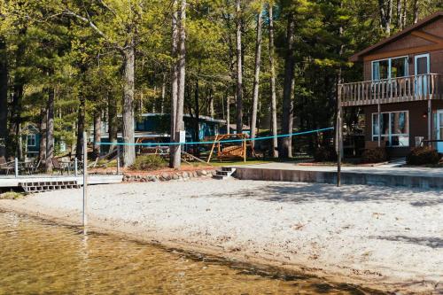 a park with a playground in front of a house at TC Lake Stay-Pontoon & SUP Rentals - Sleeps 4! in Traverse City