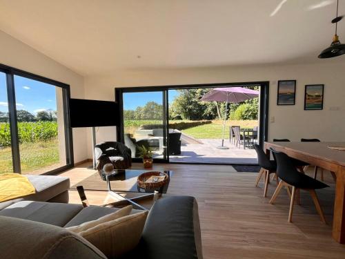 un salon avec un canapé et une table dans l'établissement Maison bretonne rénovée à 20 min des plages, parking privé, à Grand-Champ