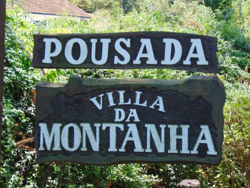 a sign for a puchada villa de montana at Pousada Villa Da Montanha in São Bento do Sapucaí