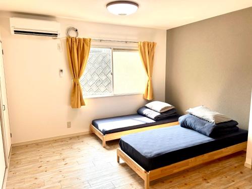 Giường trong phòng chung tại ゲストハウスＥｎ