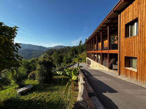 a wooden building with a view of a mountain at QG Quinta de Grovelas in Balança