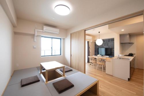 a kitchen and a living room with a table at THE RISE Osaka Universal Bayside in Osaka