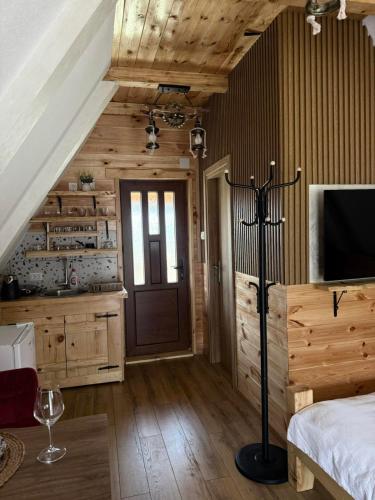 a bedroom with a bed and a television in a room at Vekova koliba in Žabljak