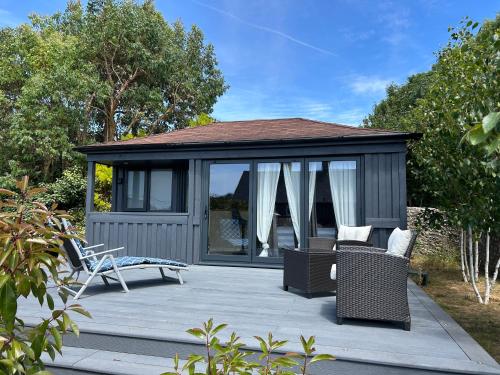 a gazebo with chairs and tables on a patio at Stylish Cabin in East Sussex near Newhaven ferry in Newhaven
