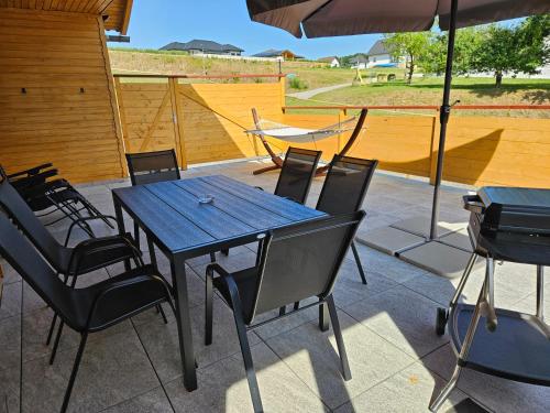 a table and chairs with an umbrella on a patio at Wellness Apartment 