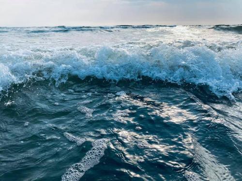 a wave with footprints in the ocean at Pilava in Roja