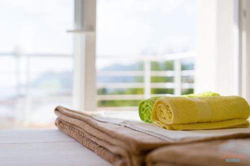 a pile of towels sitting on top of a table at Dubrava Rooms in Dobra Voda