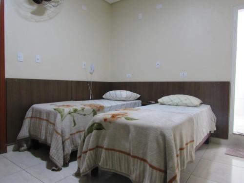a room with two beds with blankets on them at Las Vegas Hotel in Sao Paulo