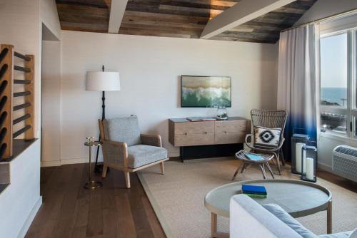 a living room with a couch and chairs and a table at Gurney's Montauk Resort & Seawater Spa in Montauk
