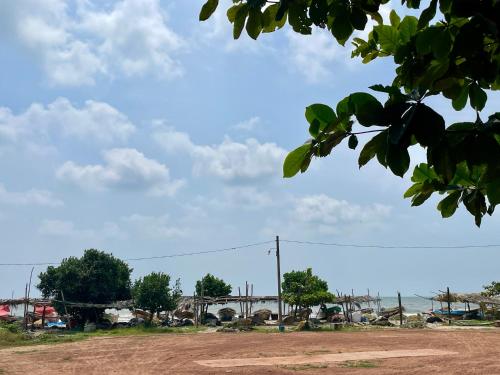 a view of a dirt road with a sky at Curly Hostel Negombo in Negombo