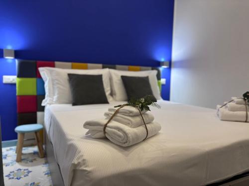 a bedroom with two beds with towels on them at Ognissanti Rooms in Acireale