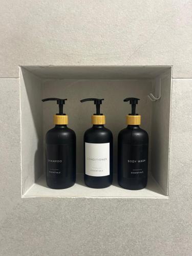 three black and yellow bottles in a box at Private Patio Przno Steps to Beach 2 Bedroom 2 Parkings BBQ Villa Olive in Sveti Stefan