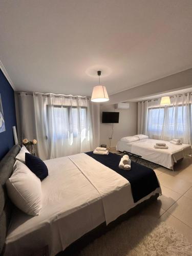 a bedroom with two beds and a tv at Mytilene Luxury Villa Panoramic in Mytilini