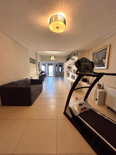 a living room with a couch and a treadmill at Mytilene Luxury Villa Panoramic in Mytilini