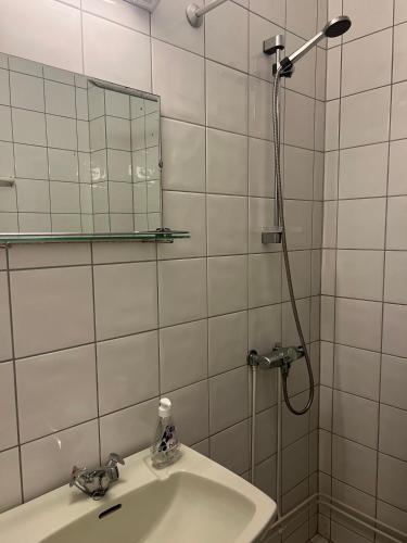 a bathroom with a sink and a shower with a mirror at Krossbu in Boverdalen