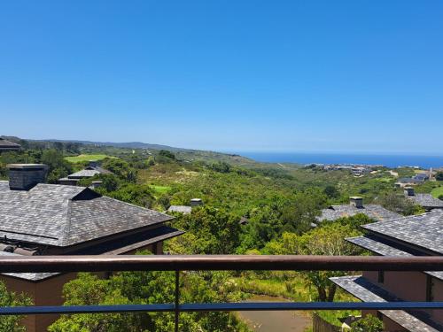 a view of the ocean from the balcony of a house at Pezula Nature Retreat in Knysna