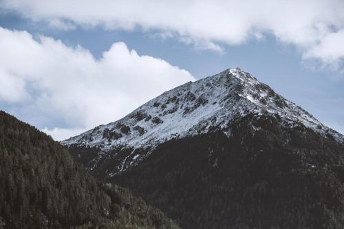 a snow covered mountain in the distance at Pension Neururer in Sölden