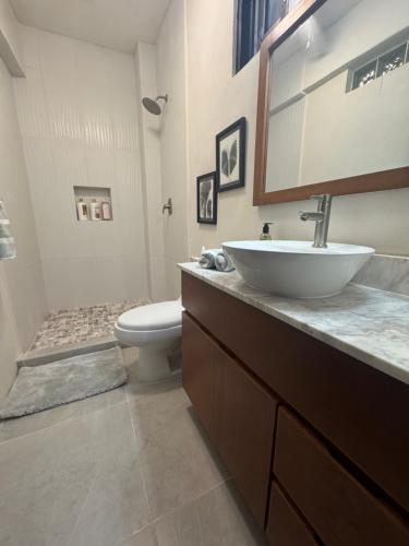 a bathroom with a sink and a toilet at Playanet in Chelem