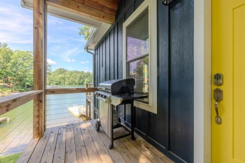 a grill on the porch of a tiny house at Unwind at Lakey McLakehouse on Lake Santeetlah in Robbinsville