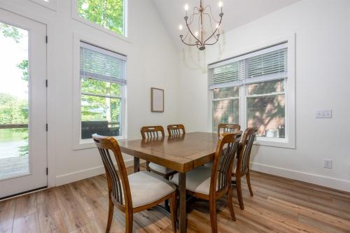 a dining room with a wooden table and chairs at Unwind at Lakey McLakehouse on Lake Santeetlah in Robbinsville