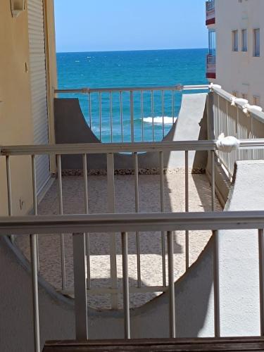 a balcony with a view of the ocean at Cozy Beachside Apartment in Tavernes de Valldigna