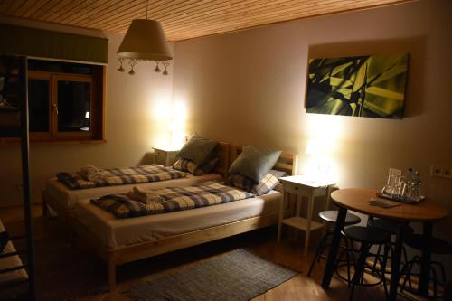 a bedroom with two beds and a table and a table at Pilava in Roja