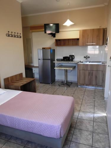 a large kitchen with a bed in a room at Asteri Studios in Kalamaki