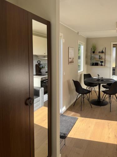 a kitchen and dining room with a table and chairs at Lakefront cabin on Skåne's largest island in Ivö