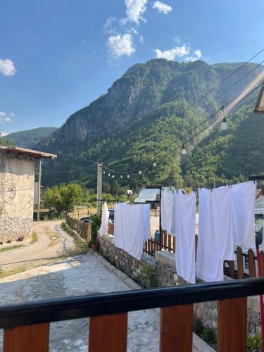 a laundry line with a mountain in the background at Guest House Shtëpiza Theth in Theth