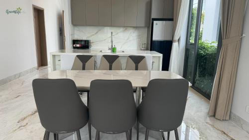 a kitchen with a table and four chairs at Greenlife Village Phú Quốc in Phu Quoc