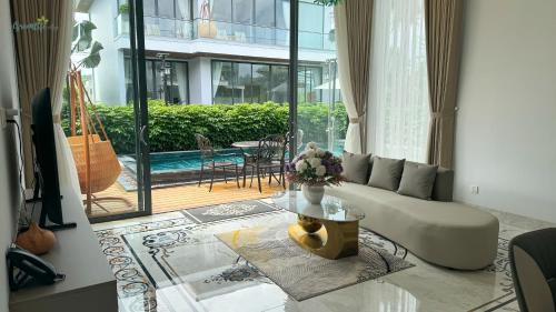 a living room with a couch and a table at Greenlife Village Phú Quốc in Phu Quoc