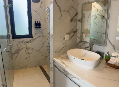 a bathroom with a sink and a shower at Greenlife Village Phú Quốc in Phu Quoc