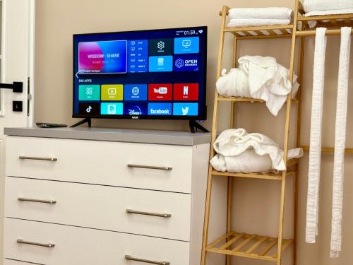 a bedroom with a tv on top of a dresser at Guest House Deon in Vlorë
