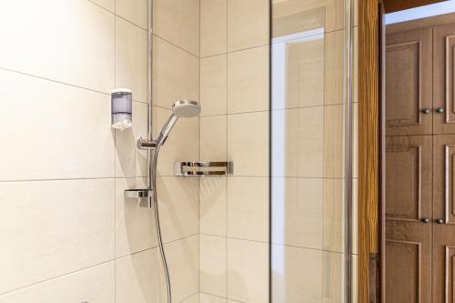 a shower with a shower head in a bathroom at Pension Neururer in Sölden