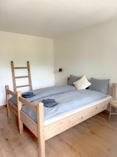 a large bed with a wooden frame in a room at Gorgeous Modern Mountain View Flat in Täsch in Täsch