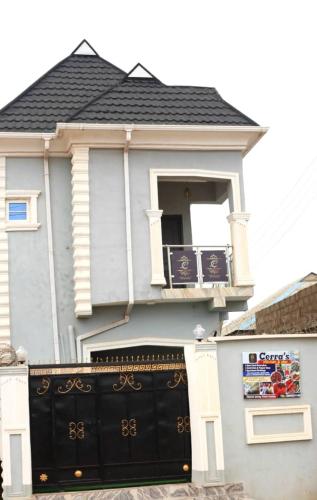 a house with a black gate with a balcony at Cerra's lodge in Otta