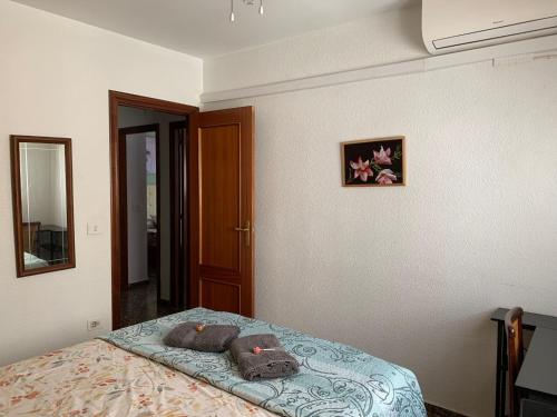 a bedroom with a bed with two pillows on it at Plaza Mare Nostrum 5 min playa in Puerto de Sagunto