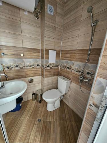 a bathroom with a toilet and a sink at Студио Морелия in Tsarevo