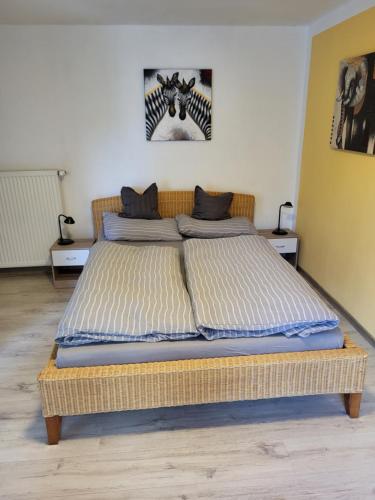a large bed in a room with two tables at Ferienwohnung Muttental in Witten