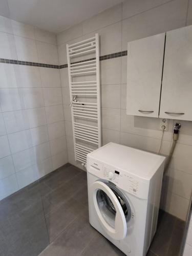 a white washer and dryer in a room at Ferienwohnung Muttental in Witten