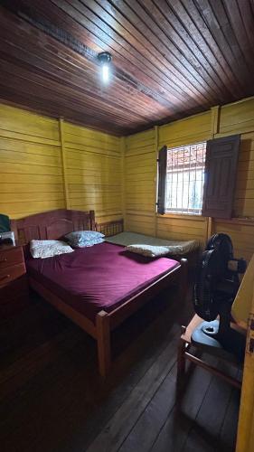 a bedroom with a large bed in a wooden room at Cop30 in Belém