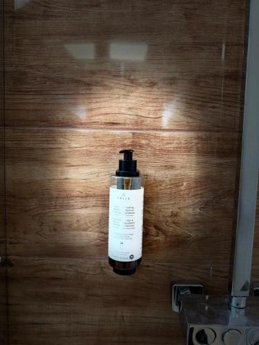 a bottle of soap sitting on a wooden floor at Dom wakacyjny z podgrzewanym basenem w tarasie i jacuzzi pod gwiazdami, Studnica, Ińsko, "THerapeutica" 