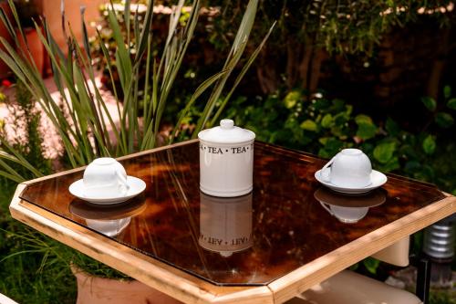 a table with two white hats on top of it at Chalet berbère 2 Chambres avec Piscine &Wifi fibre in Essaouira